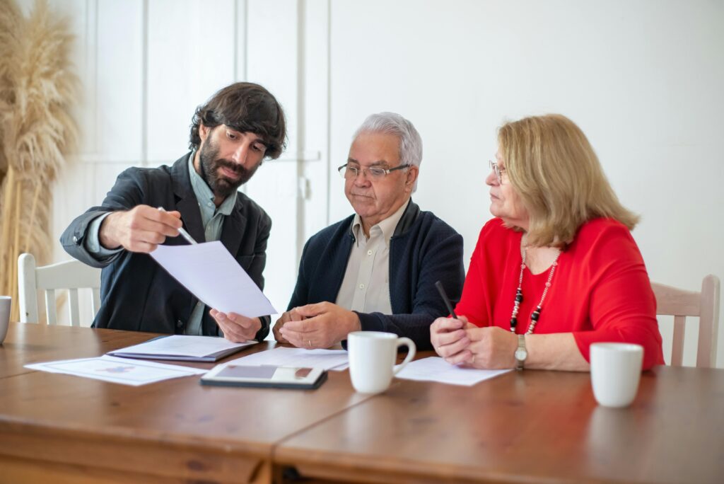 Accountant advising senior couple on financial documents.